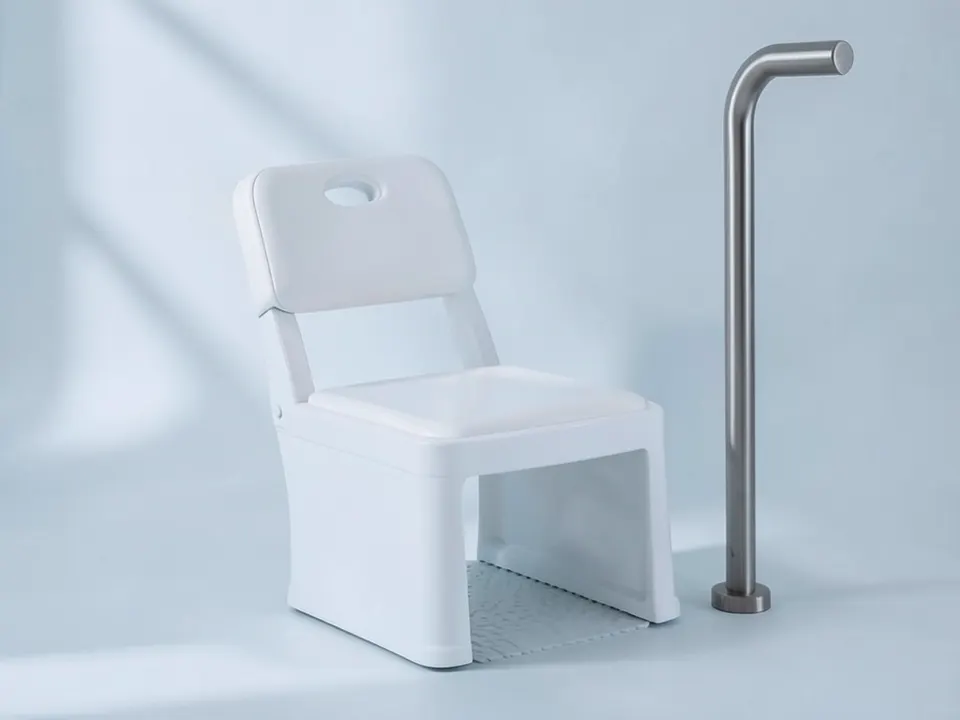 White shower chair with backrest beside a stainless steel grab bar